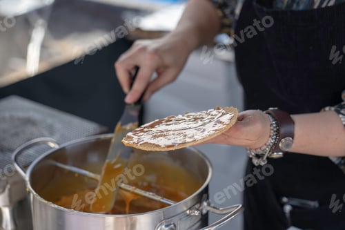 Preview: lady at local markets making stroopwafel/ dutch waffles with syrup