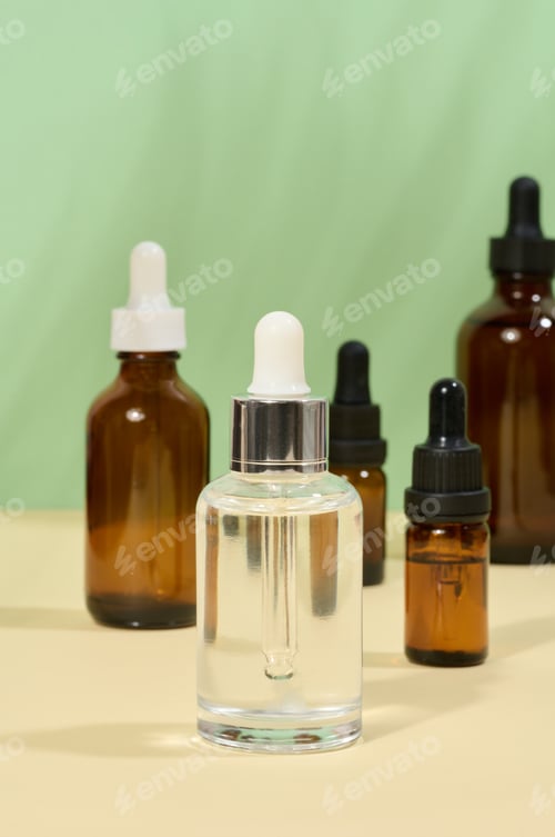 Preview: Glass bottles for cosmetics, oils with a pipette on a beige background