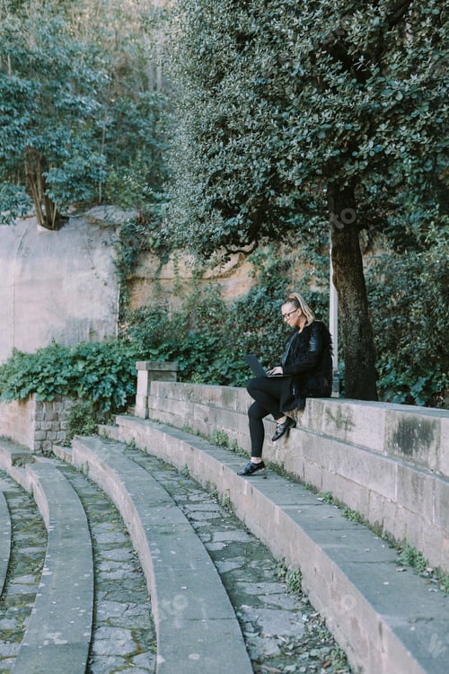Preview: Woman Works On Laptop in an Outdoor Amphitheater