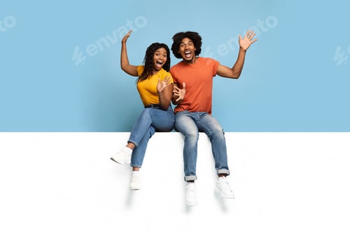 Preview: Excited black lovers sitting on horizontal white board