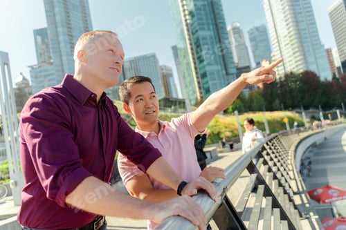 Preview: Attractive gay men, homosexual family standing looking away, Asian partner pointing with finger