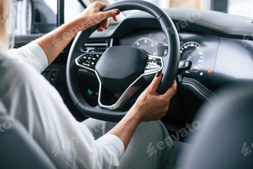 Preview: Modern quality interior. Woman is sitting in a car and driving it