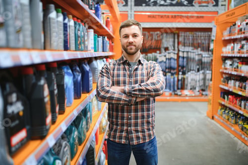 Preview: seller man with canister of motor oil in auto store