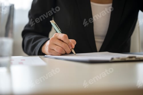 Preview: Low angle view of a woman signing contract