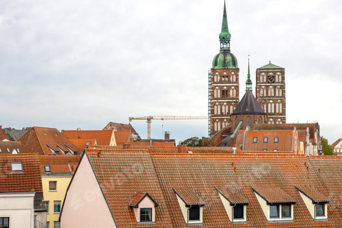 Preview: Brick Gothic above tiled roofs. European old town.