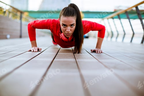 Preview: Young woman exercises on the promenade after running