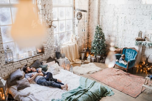 Preview: Winter weekend at home. Young caucasian couple in cozy clothes hugging in bed.