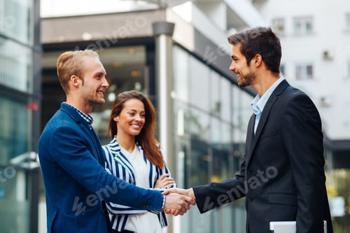 Preview: Business people handshake outdoor