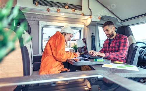 Preview: Woman and man telecommuting during a camper van trip