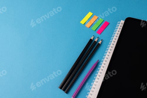 Preview: Image of various office supplies, pens and notebook on blue background