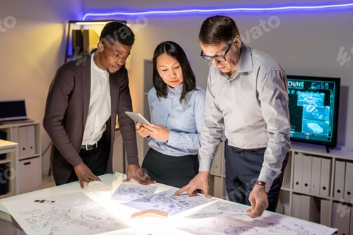 Preview: Team of Automotive Engineers Discussing Car Sketches