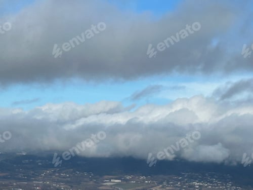 Preview: Puffy Clouds in the skies above the mountains