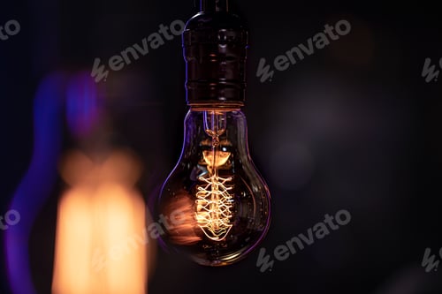 Preview: Close up of a burning lamp on a blurred dark background.