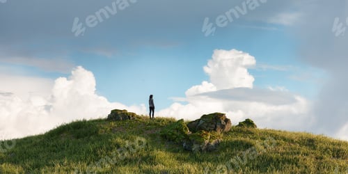 Preview: Magical fantasy scene with woman on top of hill and mountain landscape in background