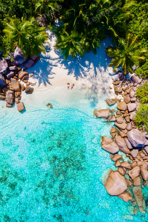 Preview: Anse Lazio Praslin Seychelles, a young couple of men and women on a tropical beach during vacation