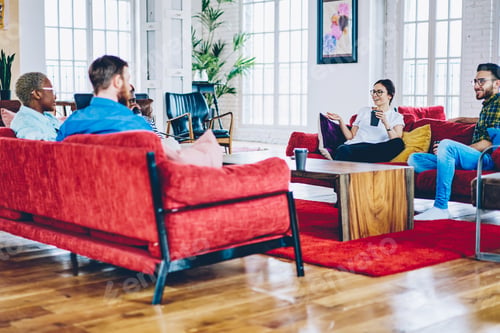 Preview: Diverse hipster guys with coffee to go communicate in flat