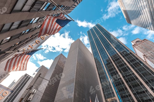 Preview: Skyscrapers in Manhattan with American flags and sky above