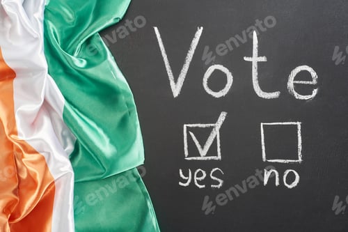 Preview: top view of white vote lettering and check mark near yes word on black chalkboard near flag of