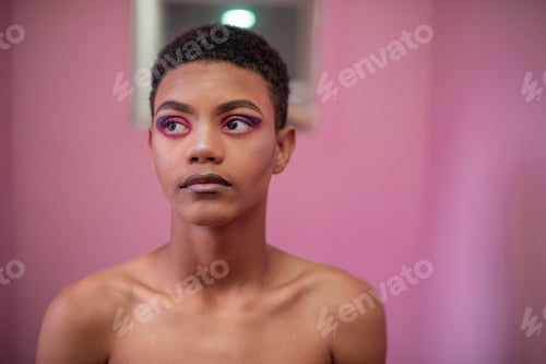 Preview: Portrait of young queer person with pink background