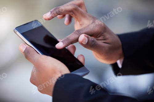 Preview: Shot of an unrecognizable businessman using a phone in the city