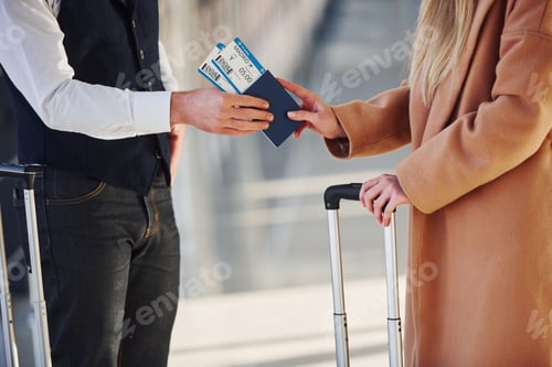 Preview: Close up view of woman that gives tickets to security man in airport