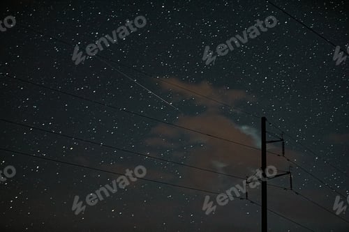 Preview: Night Starry Sky With Glowing Stars And Meteoric Track Trail. Power Lines In Starry Sky Background