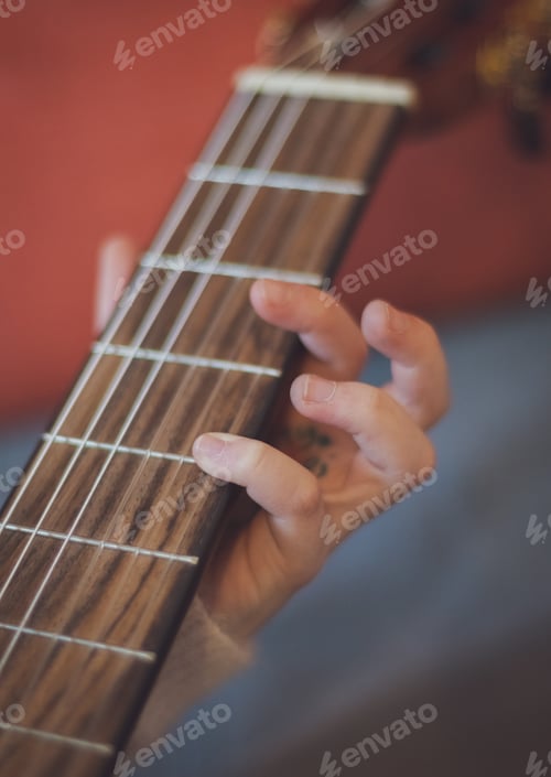 Preview: Little girl plays the guitar.