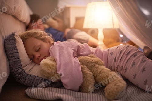Preview: Sleeping tight with sweetdreams. Cropped shot of siblings sleeping under a blanket fort at home.