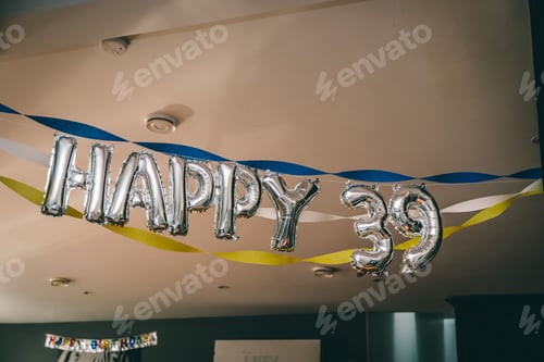 Preview: Happy 39 silver balloons hanging from the walls in the house