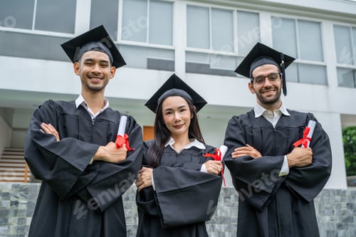 Preview: Portrait diverse students celebrating college achievement outside campus.