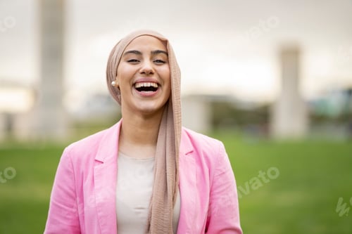 Preview: portrait of beautiful Muslim woman in hiyab happily sipping outdoors