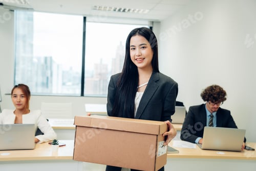 Preview: Beautiful young female carrying office box and hired for a new job.