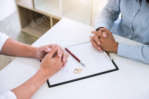 Preview: Husband and wife are reading divorce agreement and signing decree of divorce (dissolution or