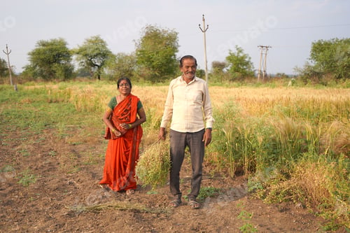 Preview: Happy Indian farmer couple in the field.