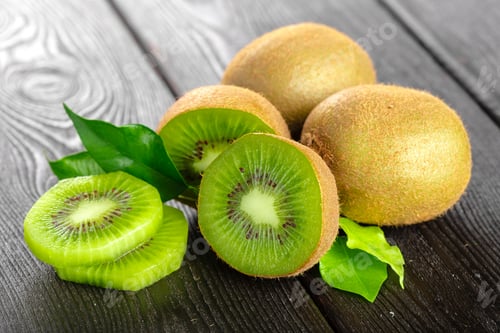 Preview: Juicy kiwi fruit on wooden table. Creative Photo
