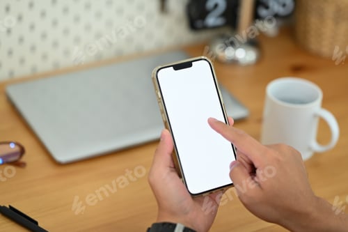 Preview: Young man hands using smartphone at workplace. Blank screen for your advertising text message