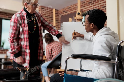 Preview: Senior teacher explaining sketching technique to impaired student