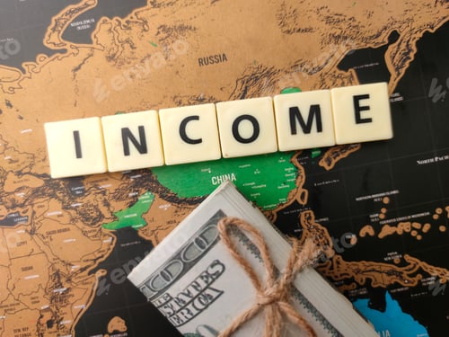 Preview: Toys word and banknotes with the word INCOME on a world map background.