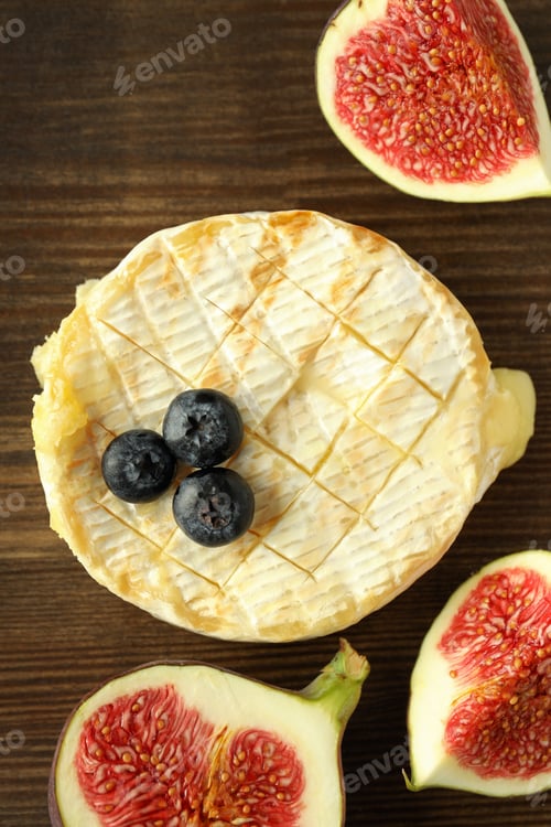 Preview: Concept of tasty food with grilled camembert on wooden background