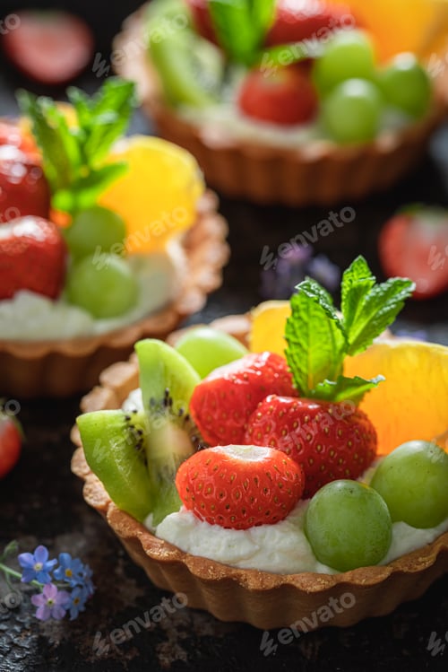 Preview: Delicious mini tart with strawberries, orange, kiwi and grapes