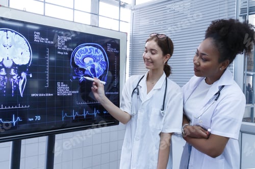 Preview: female doctor students team meeting and analyzing brain MRI scan