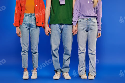 Preview: alternative family, polygamy, partial view of polyamory three people, young man and women holding