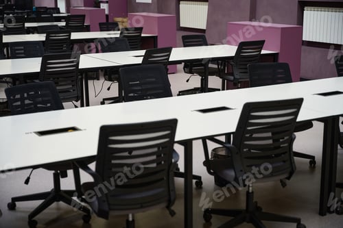 Preview: Office with rows of tables and chairs standing near them
