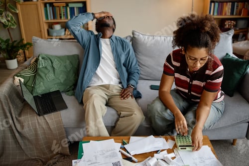 Preview: Young Couple Analyzing Bills and Invoices at Home