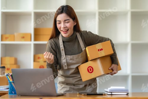 Preview: Asian Small business entrepreneur SME working with box and Surprised to look at the notebook screen