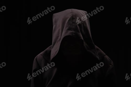 Preview: medieval monk with face under dark hood isolated on black
