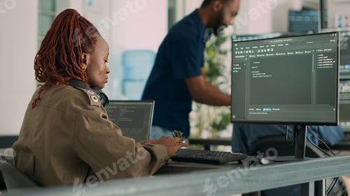 Software developer typing programming code on computer