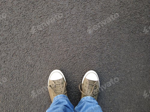 Preview: foot selfie or feet in canvas shoes standing on asphalt