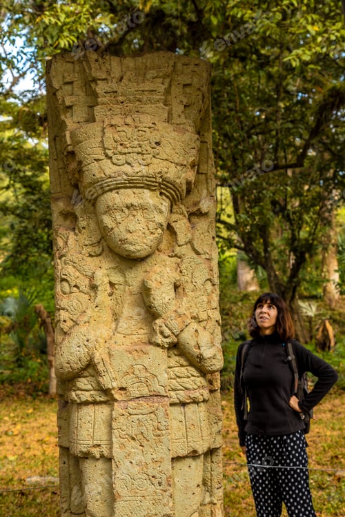 Preview: A woman in to detail of a figure in The temples of Copan Ruinas. Honduras