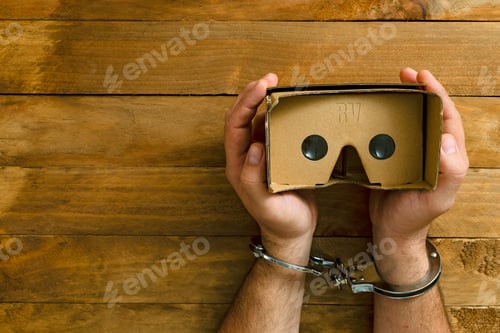 Preview: Cuffed Hands Holding a Virtual Reality Headset